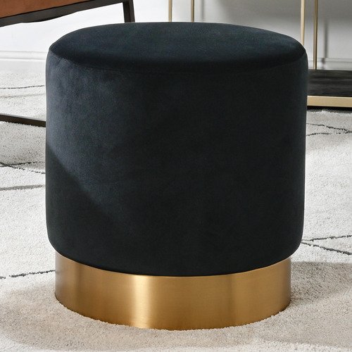 Round velvet ottoman in dark fabric with brushed gold base, ideal for seating or footrest in modern spaces.