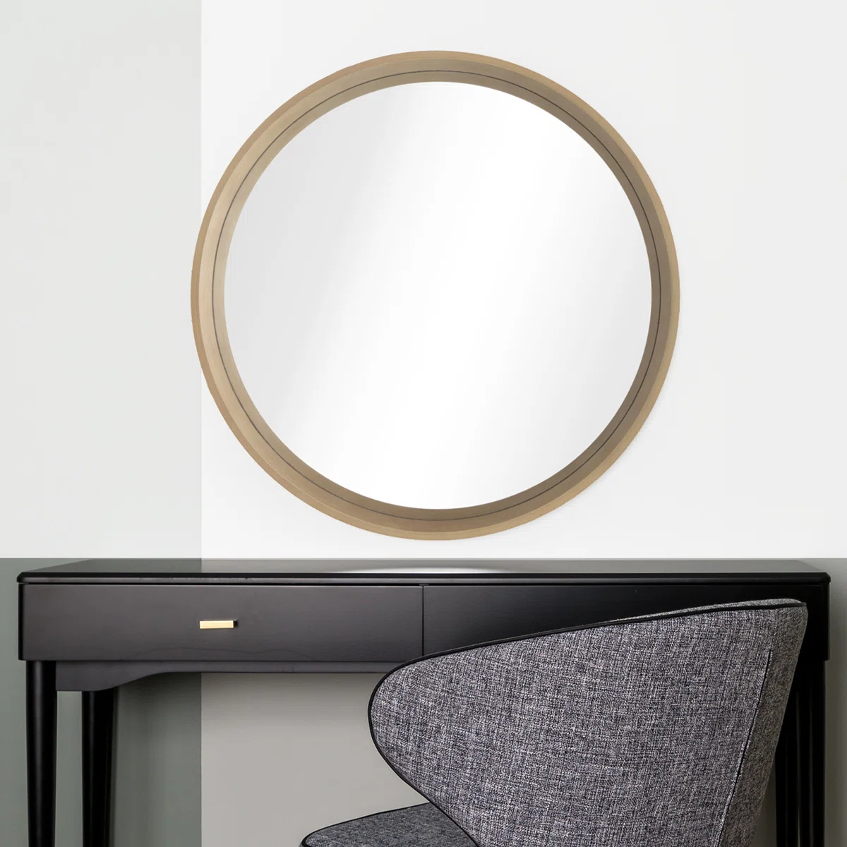 Round wall mirror with a light wood frame mounted on a white wall, showcasing a minimalist design ideal for modern and rustic interiors.