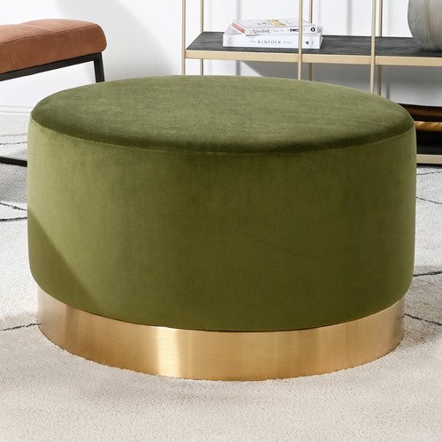 Round olive green velvet ottoman with metallic gold base on a light geometric-patterned rug.
