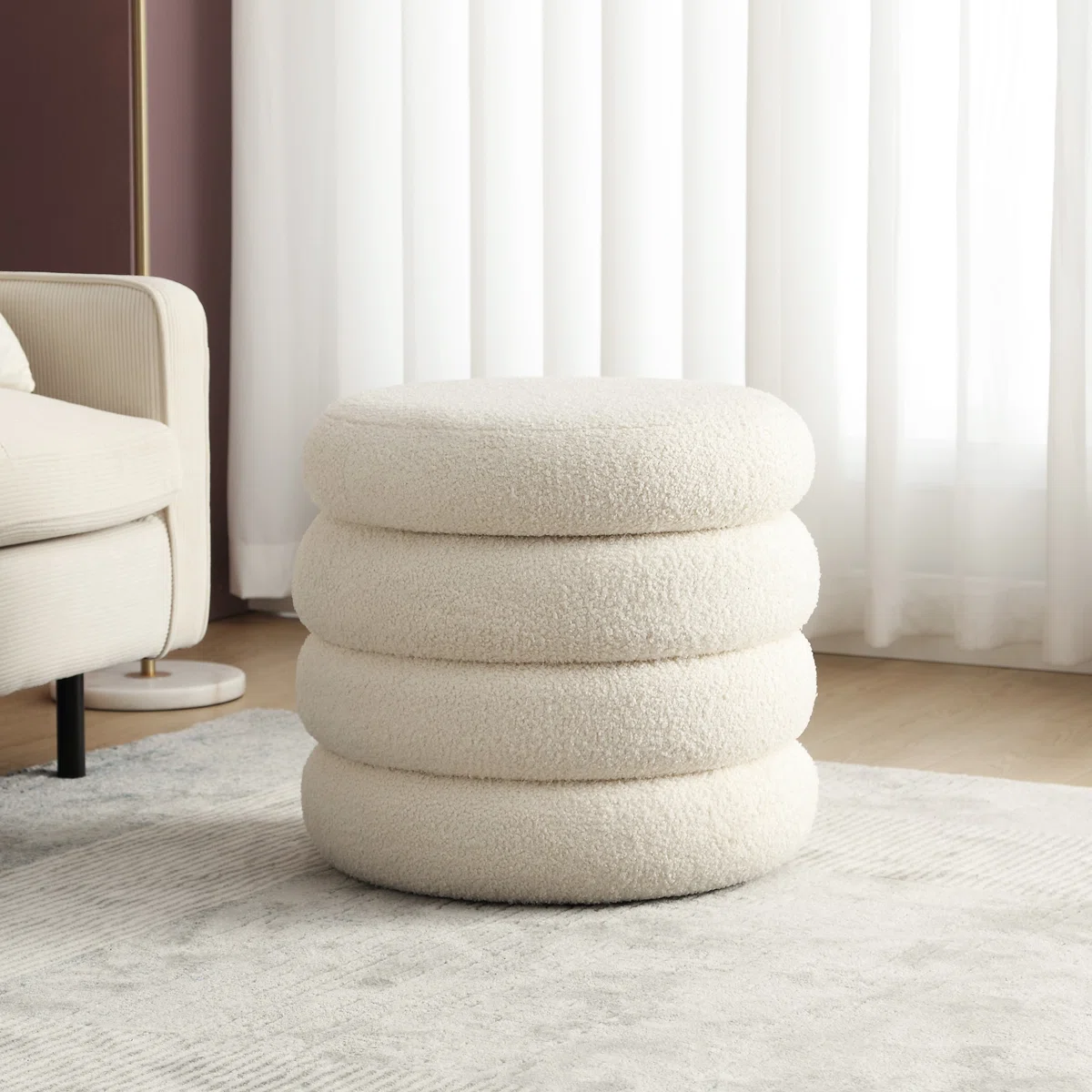 cream boucle sculptural ottoman with stacked cushion design in modern interior