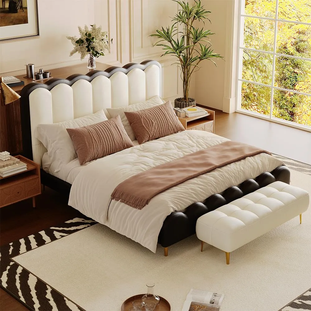 A luxurious bedroom featuring a scalloped headboard upholstered in alternating black and white segments, paired with a matching bench in white fabric and gold legs.