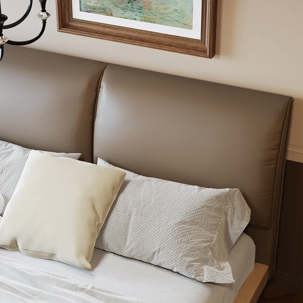Queen-size coffee faux leather bed with metal legs, gray bedding, and wooden nightstands in a modern bedroom.