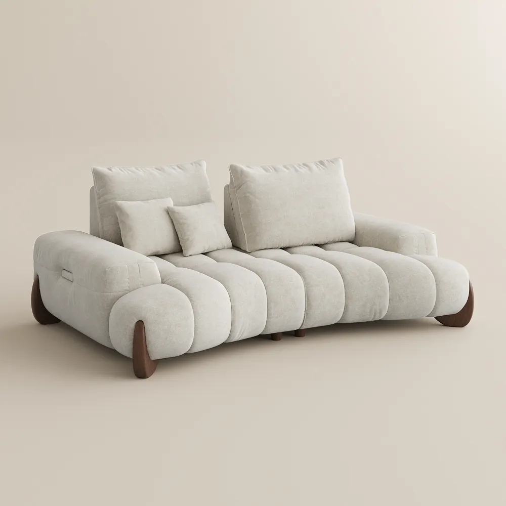 Cream sofa with quilted cushions, wide armrests, and wooden legs in a bright contemporary room