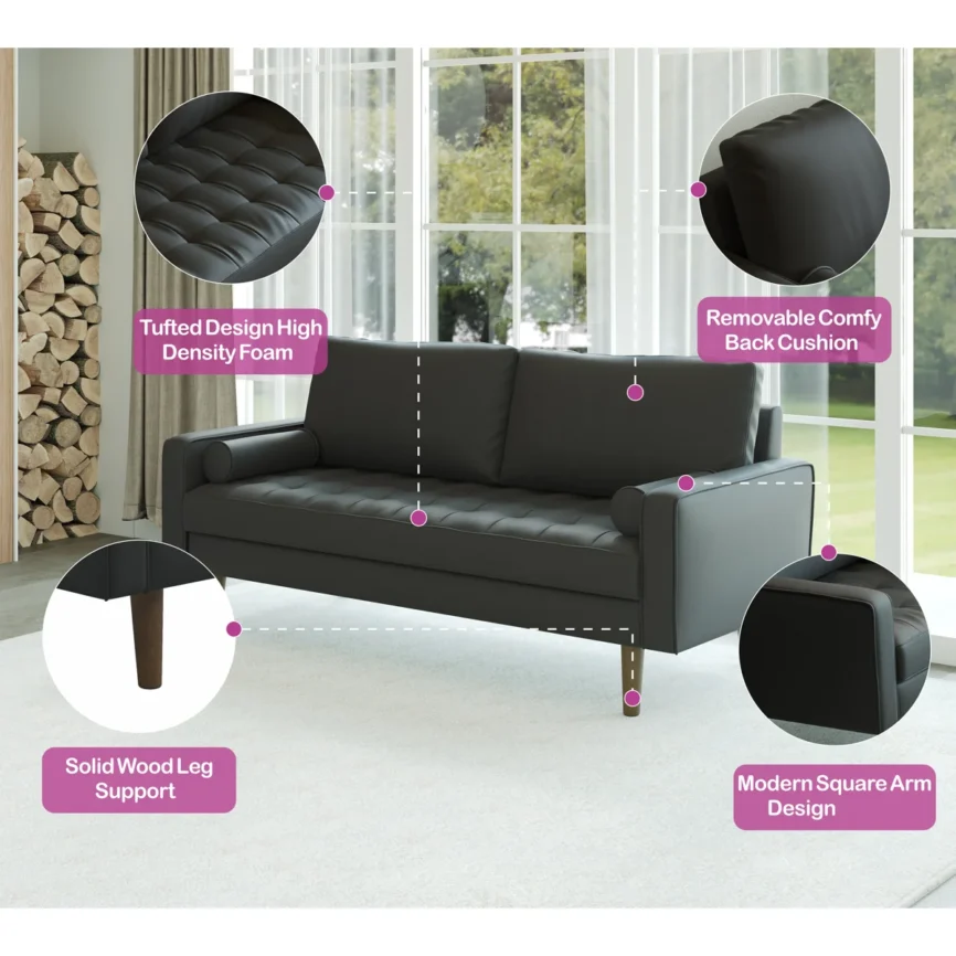 Modern black faux leather sofa with tufted seat, bolster pillows, and wooden legs in a bright room.