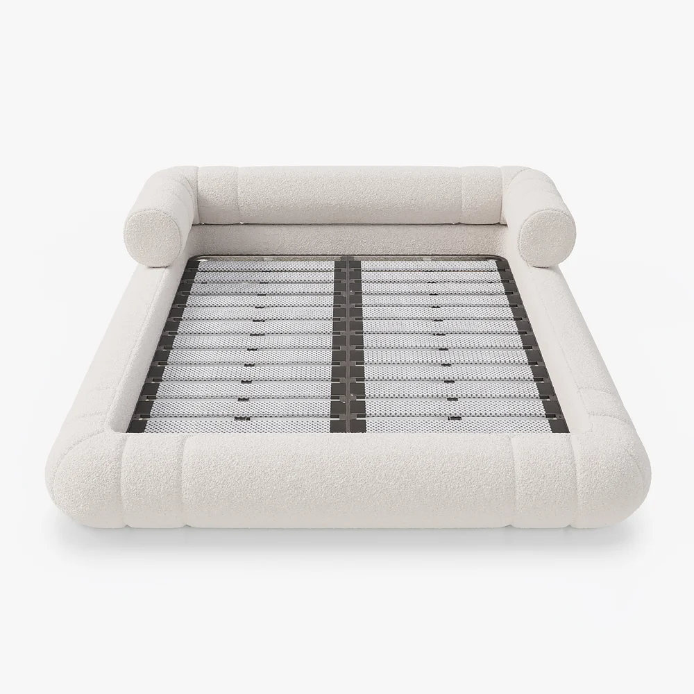 A plush queen-size floor bed upholstered in textured white boucle fabric, featuring a rounded frame and a sculptural headboard