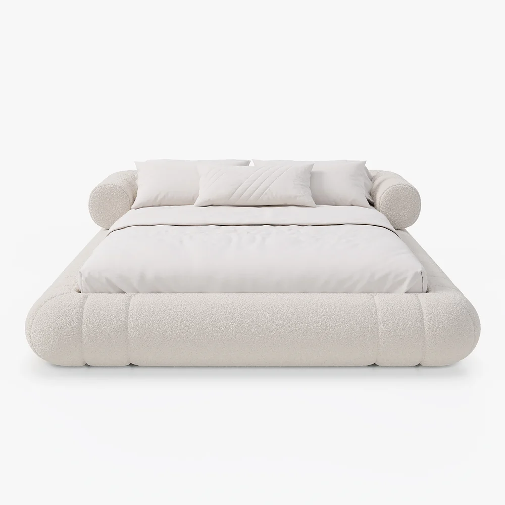 A plush queen-size floor bed upholstered in textured white boucle fabric, featuring a rounded frame and a sculptural headboard