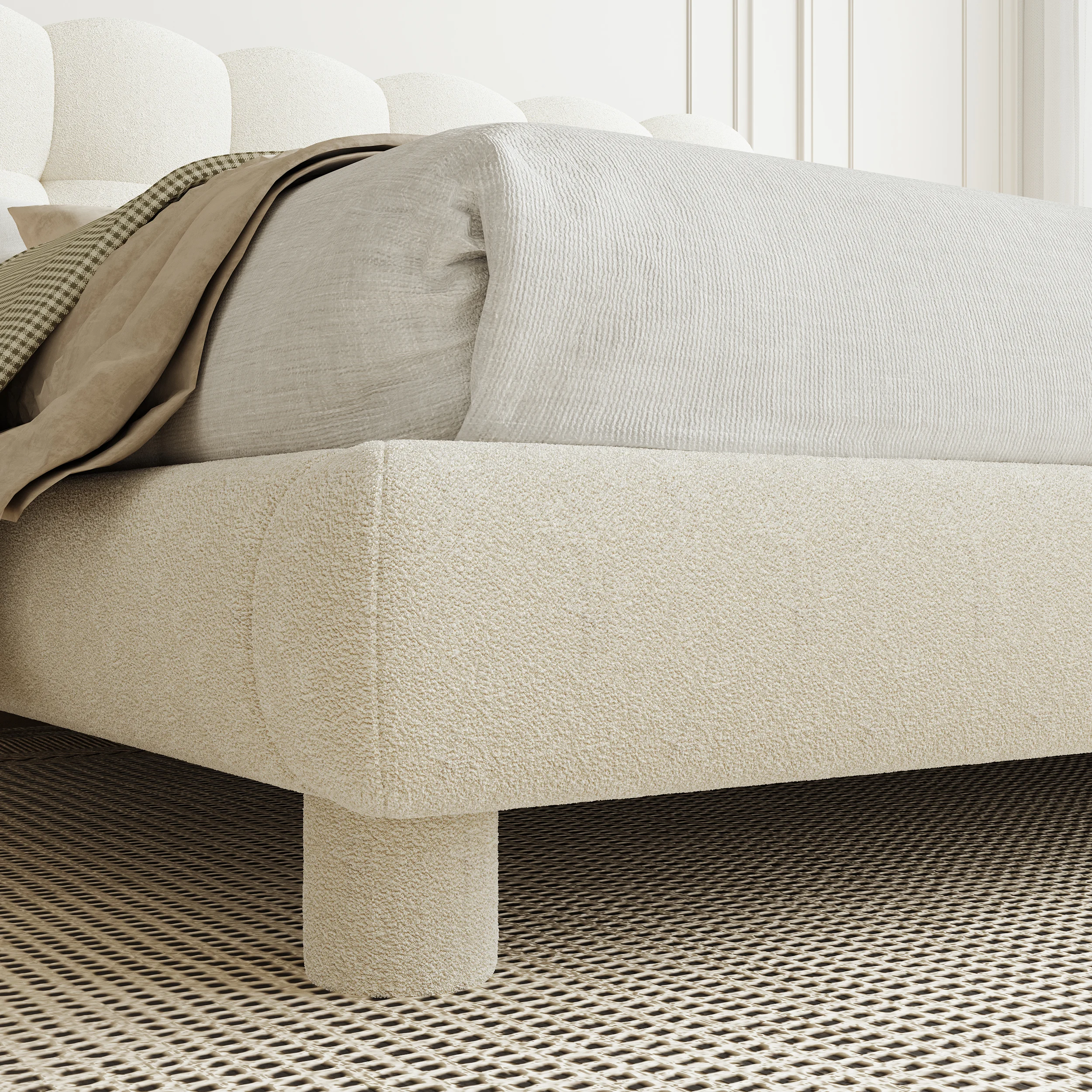 White boucle upholstered bed with tufted headboard, beige bedding, and matching nightstands in a modern bedroom.