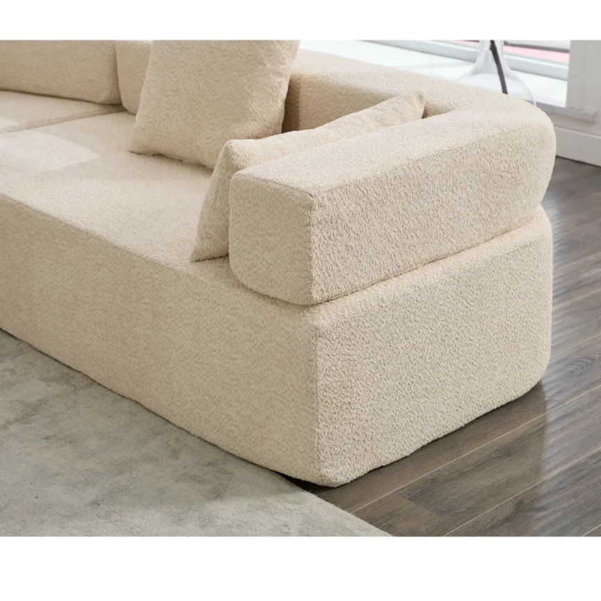Modern curved modular bouclé sectional sofa in blue fabric featuring a contemporary design, high-density foam cushions, square arms, and decorative throw pillows