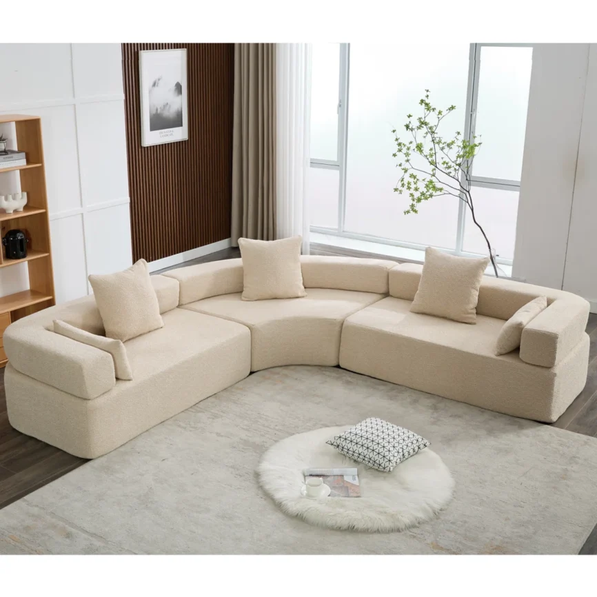 Modern curved modular bouclé sectional sofa in blue fabric featuring a contemporary design, high-density foam cushions, square arms, and decorative throw pillows