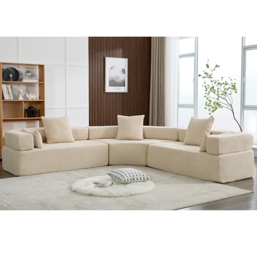 Modern curved modular bouclé sectional sofa in blue fabric featuring a contemporary design, high-density foam cushions, square arms, and decorative throw pillows