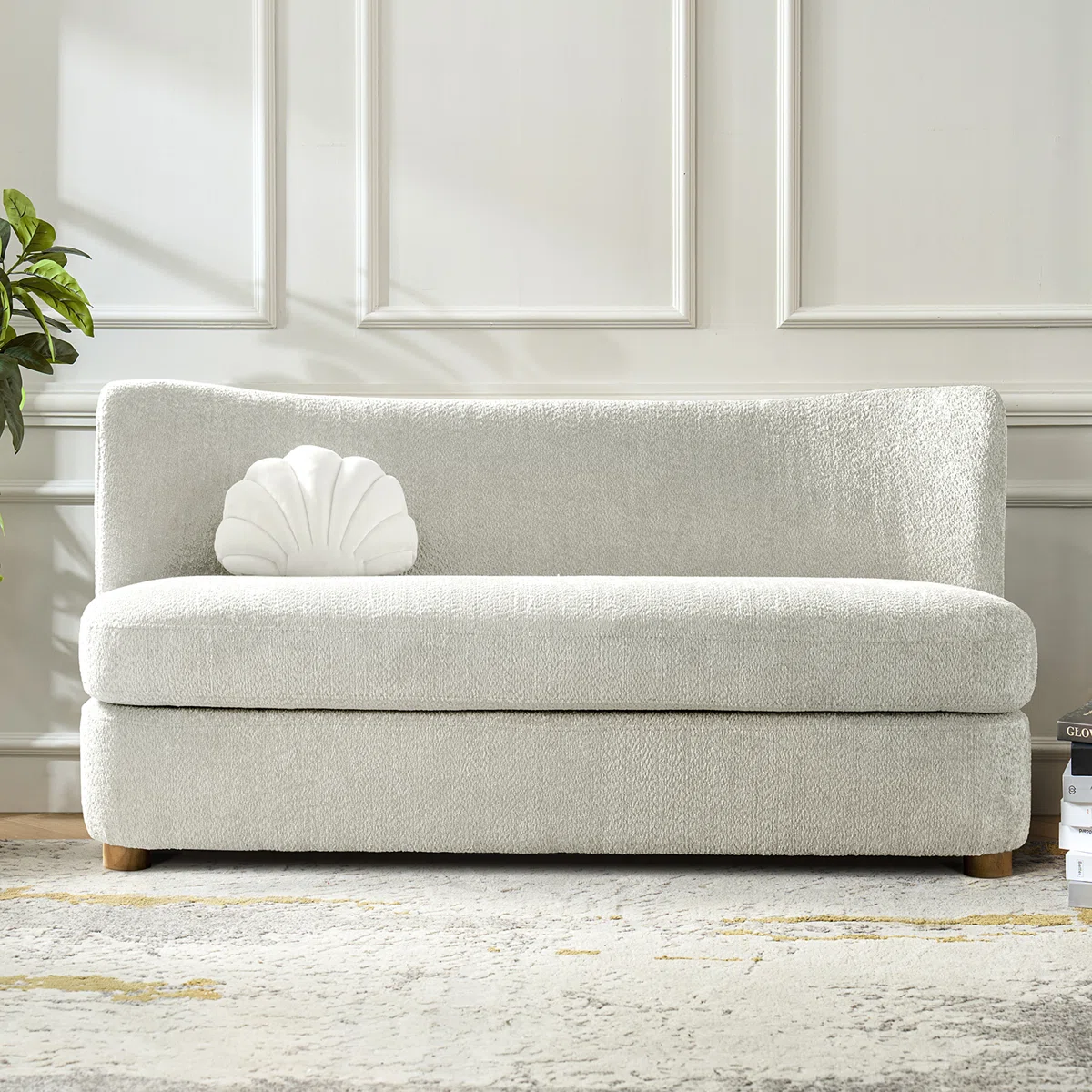 Lexie Sofa in light gray boucle with curved backrest, seashell pillow, and wooden legs in modern room