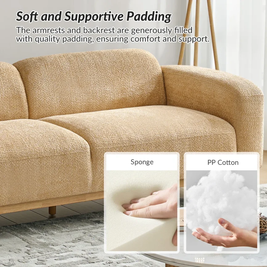 Modern beige sofa with rounded armrests and oak legs in a minimalist living room setting