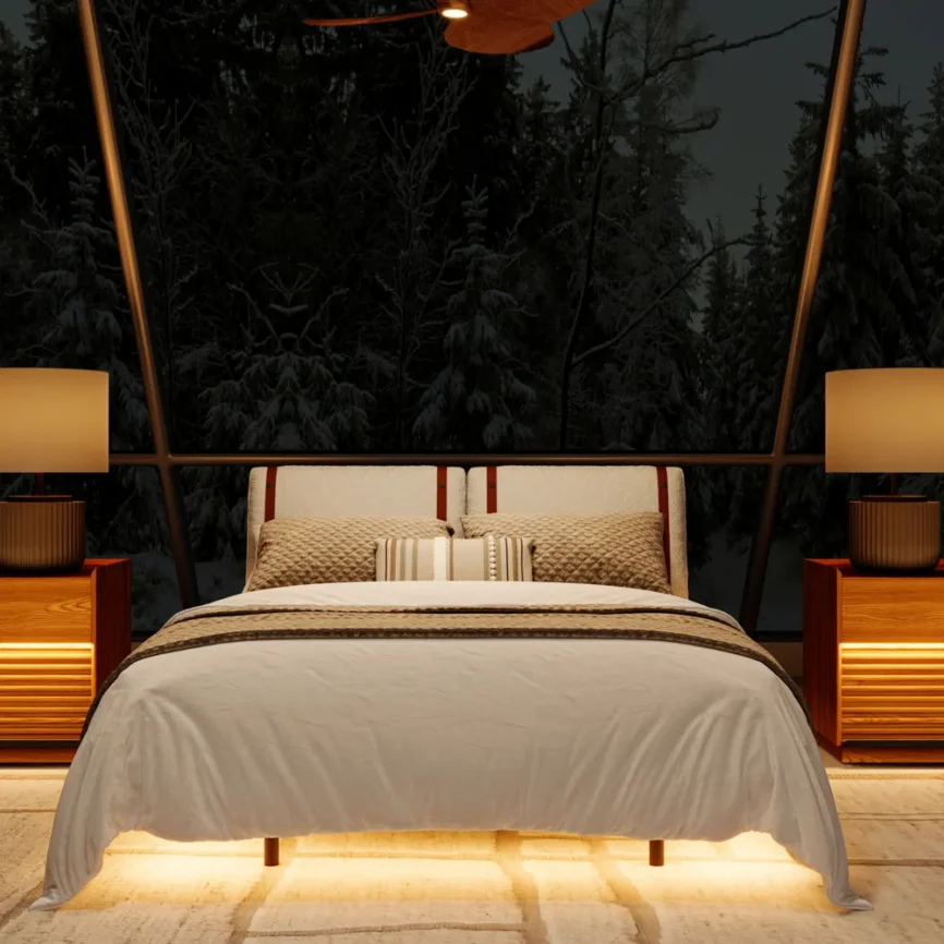 Modern bed with padded headboard, white bedding, underbed lighting, and wooden nightstands in a cozy bedroom