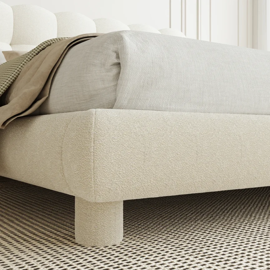 A luxurious bedroom featuring a cream upholstered platform bed with a tufted headboard