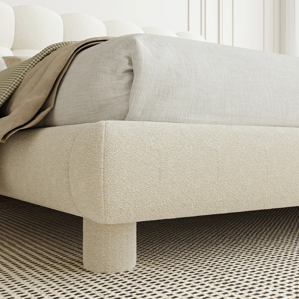 A luxurious bedroom featuring a cream upholstered platform bed with a tufted headboard