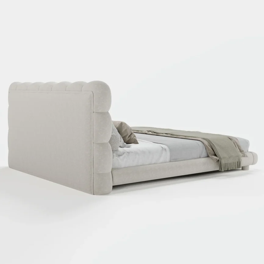 A luxurious bedroom featuring a cream upholstered platform bed with a tufted headboard