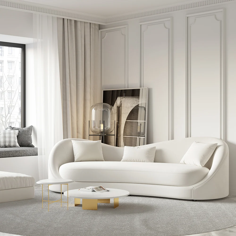 White curved 3-seater sofa with throw pillows and gold coffee table in a modern minimalist living room