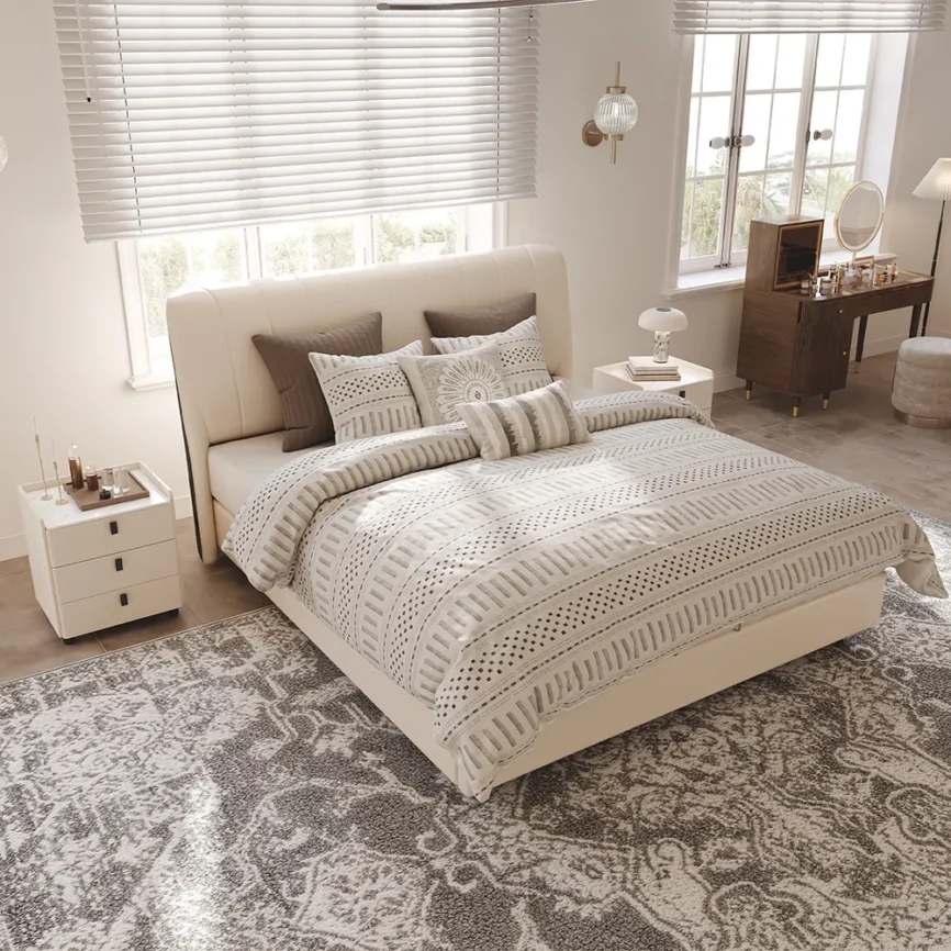 A modern bedroom featuring the Luna Beige Leather Bed, styled with a neutral-toned comforter and five decorative pi