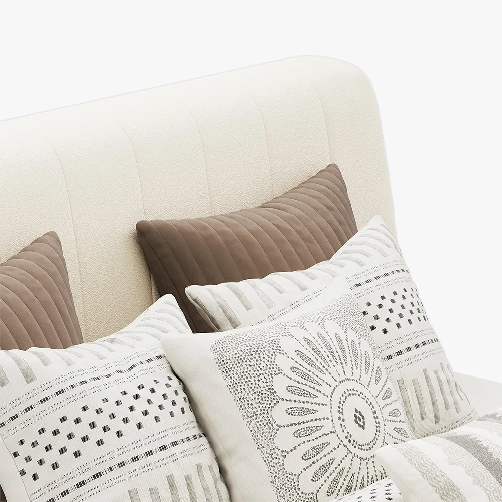 A modern bedroom featuring the Luna Beige Leather Bed, styled with a neutral-toned comforter and five decorative pi