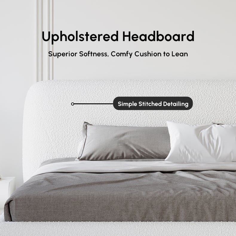 White boucle upholstered bed with padded headboard, gray bedding, and white nightstands in a minimalist bedroom.
