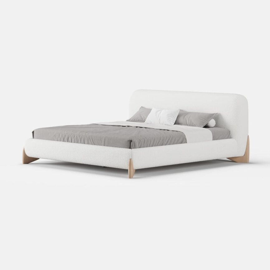 White boucle upholstered bed with padded headboard, gray bedding, and white nightstands in a minimalist bedroom.