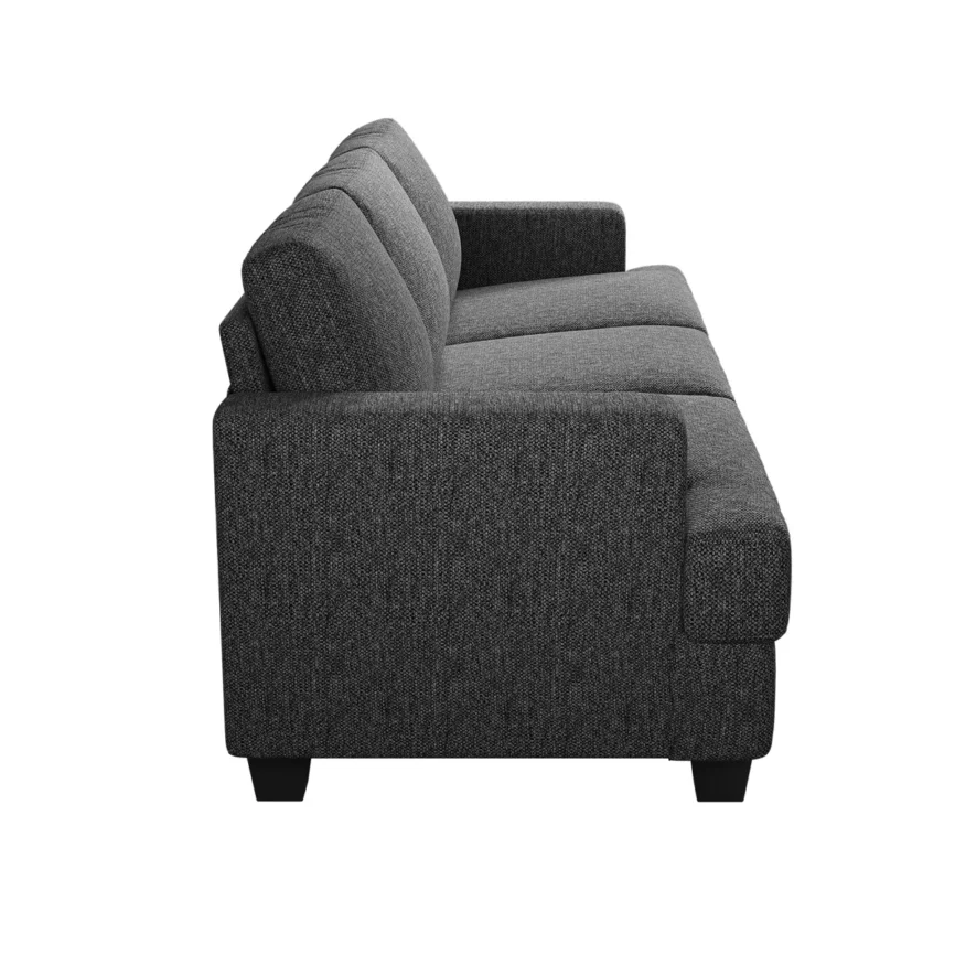Gray three-seat sofa with textured fabric, accent pillows, and throw blanket in a stylish living room.