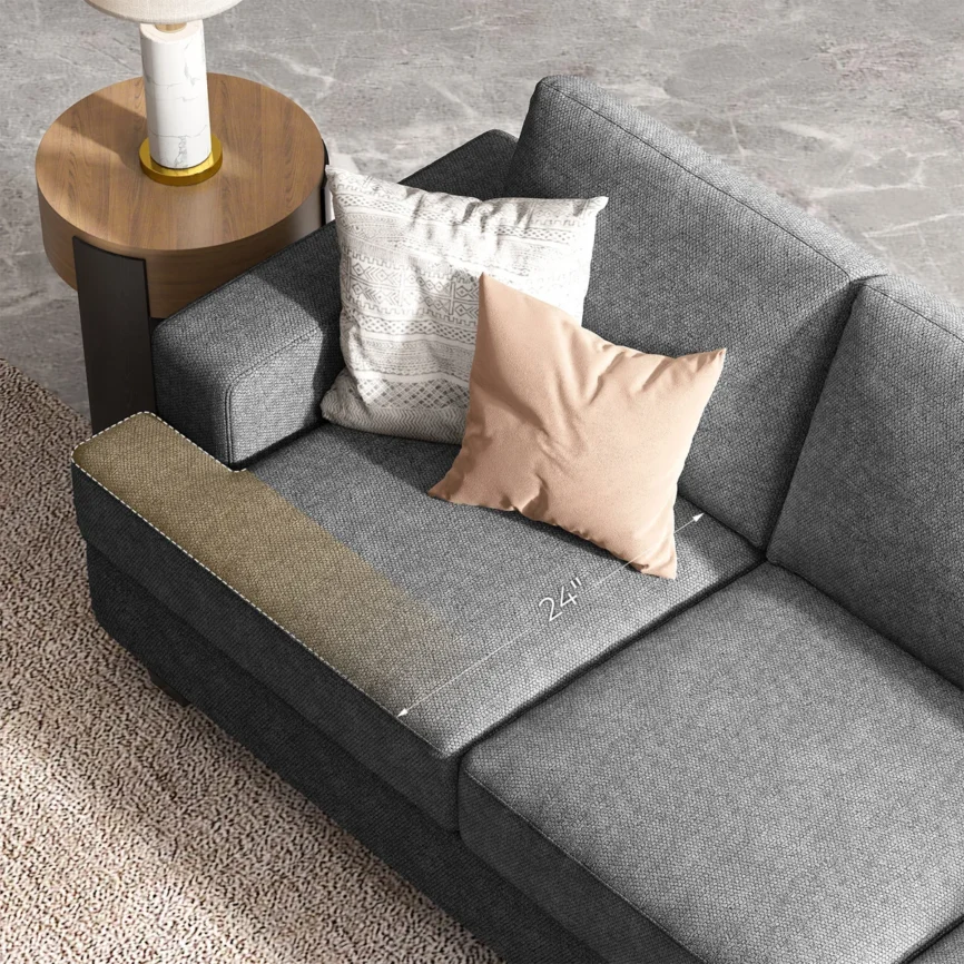 Gray three-seat sofa with textured fabric, accent pillows, and throw blanket in a stylish living room.