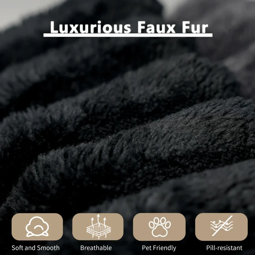 A sleek black ribbed-texture sofa with two large cushions anchors a contemporary living room. A beige throw blanket drapes over one arm, adding warmth and contrast.