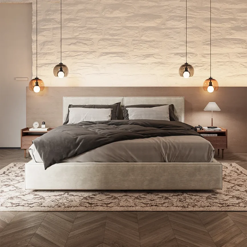 Nest Beige Fabric Bed with taupe and brown bedding, wooden nightstand, and soft lighting in a cozy bedroom.