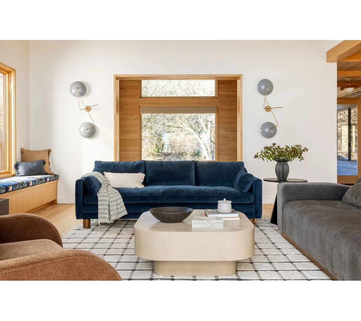 Modern dark blue sofa with three cushions, square arms, and wooden legs, highlighting modular section