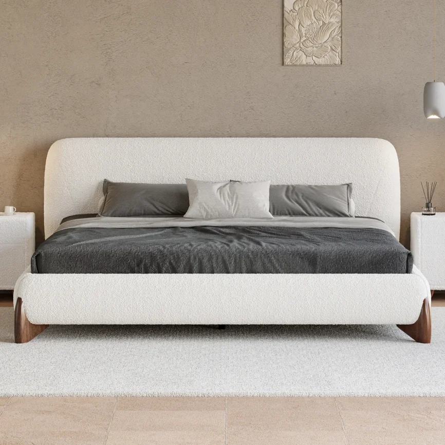 A serene bedroom featuring a white upholstered platform bed with a tufted headboard