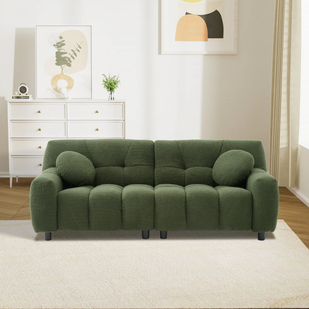 Green loveseat with tufted cushions, round pillows, and black legs in a cozy modern room
