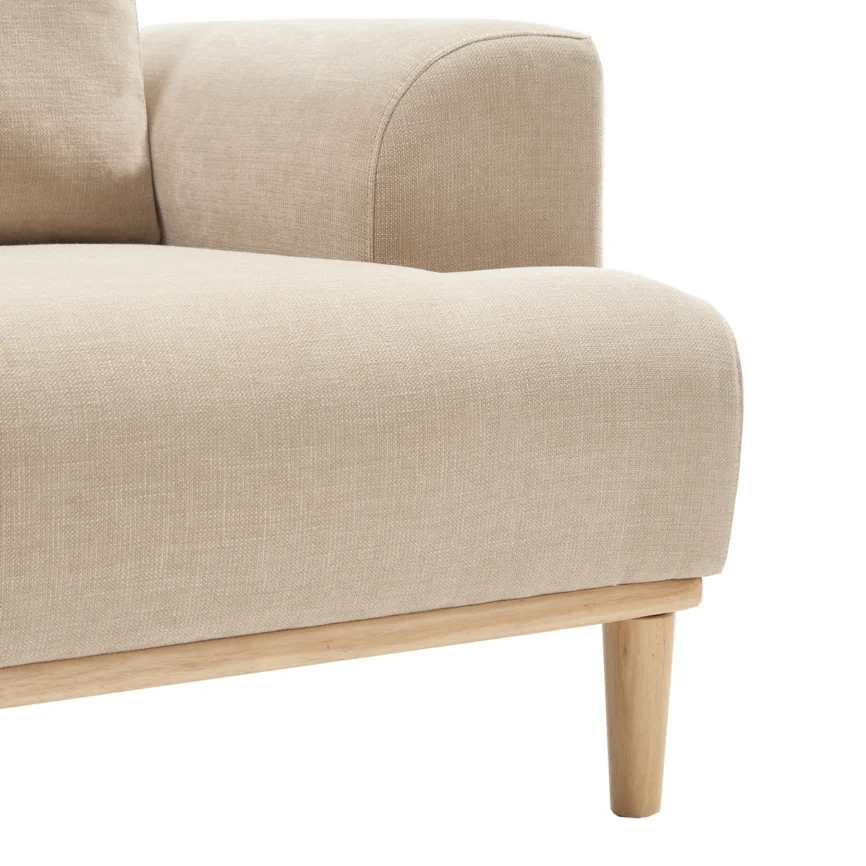 Beige sofa with wooden base and legs in a minimalist living room with neutral tones