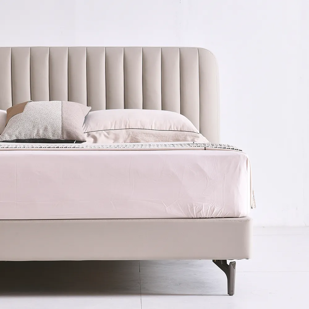 A contemporary bedroom featuring a light beige upholstered bed