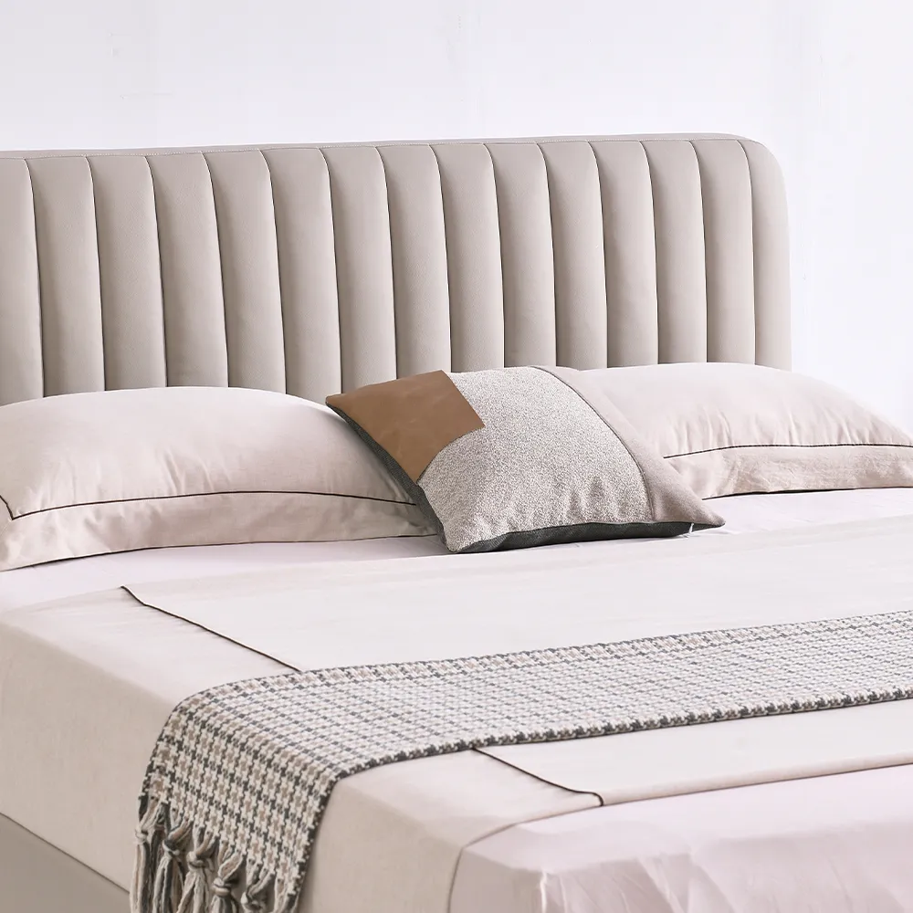 A contemporary bedroom featuring a light beige upholstered bed