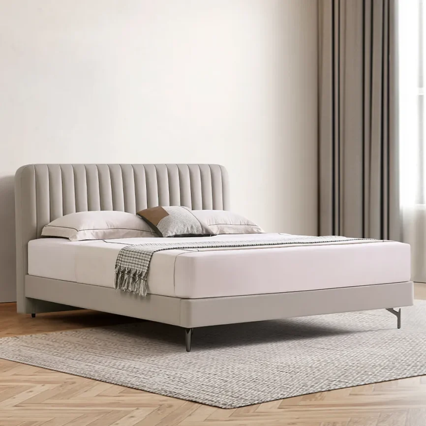 A contemporary bedroom featuring a light beige upholstered bed