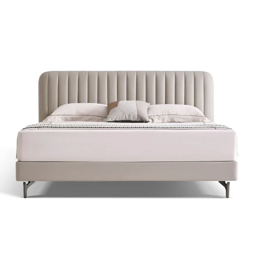 Light beige upholstered bed with vertical channeled headboard and metal legs in a modern minimalist bedroom