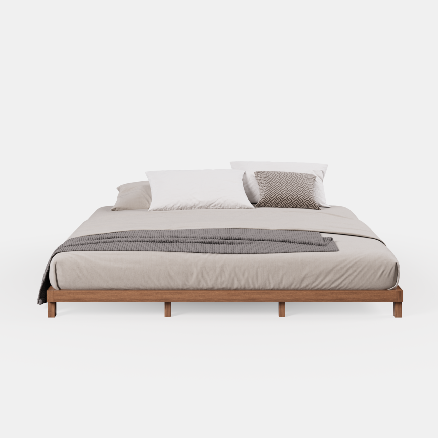 A minimalist king-size floor bed with a walnut wood finish and low-profile frame, styled with beige bedding and a textured gray throw blanket