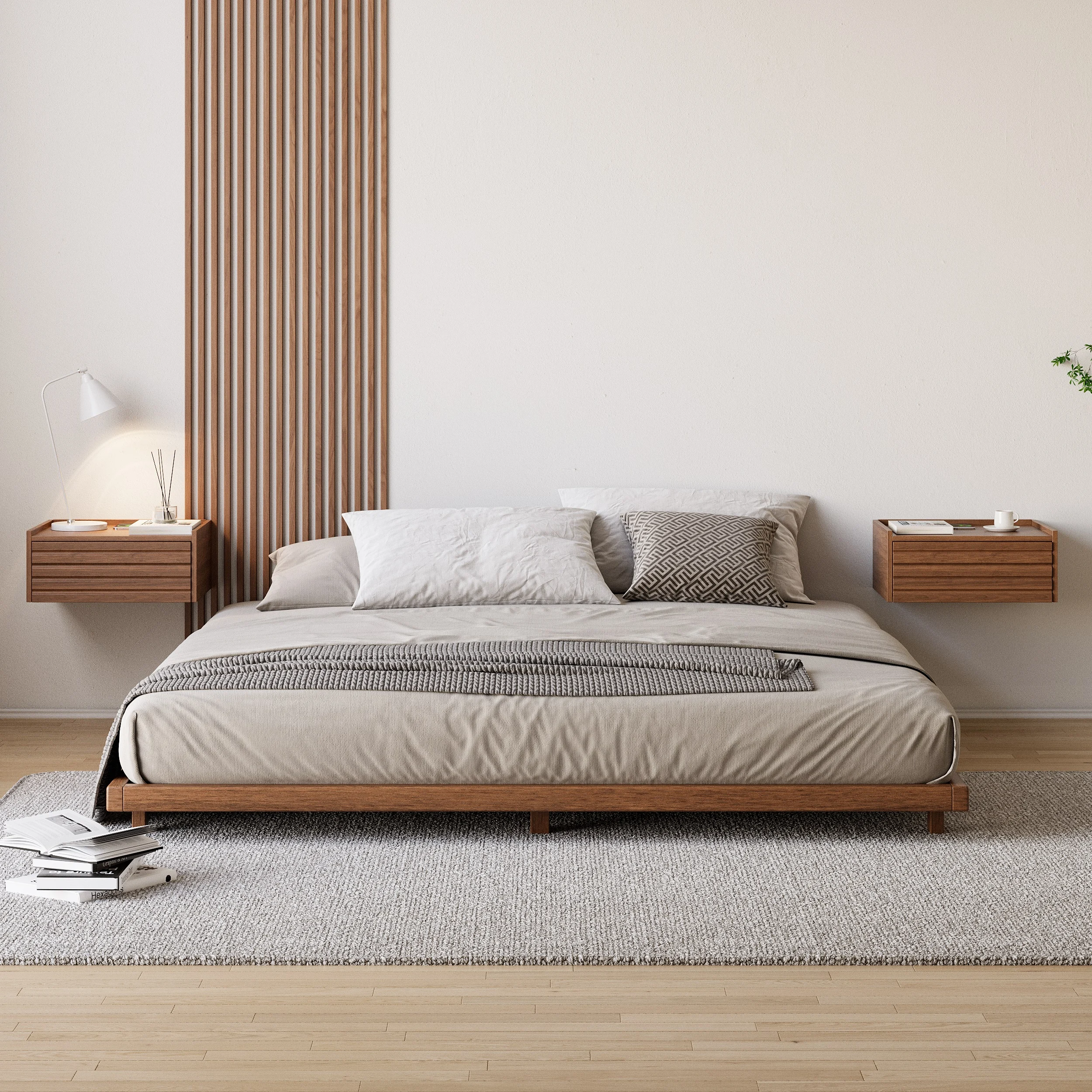 Walnut king floor bed with beige bedding, gray throw, and floating nightstands in a minimalist bedroom.