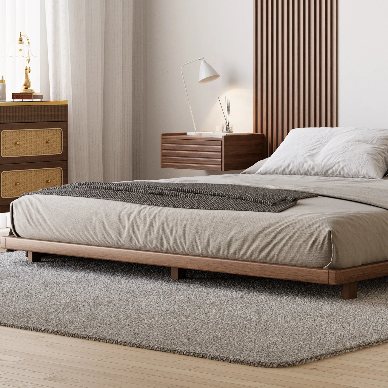 A minimalist bedroom featuring a low-profile wooden bed with a matching headboard and neutral bedding in beige and gray tones