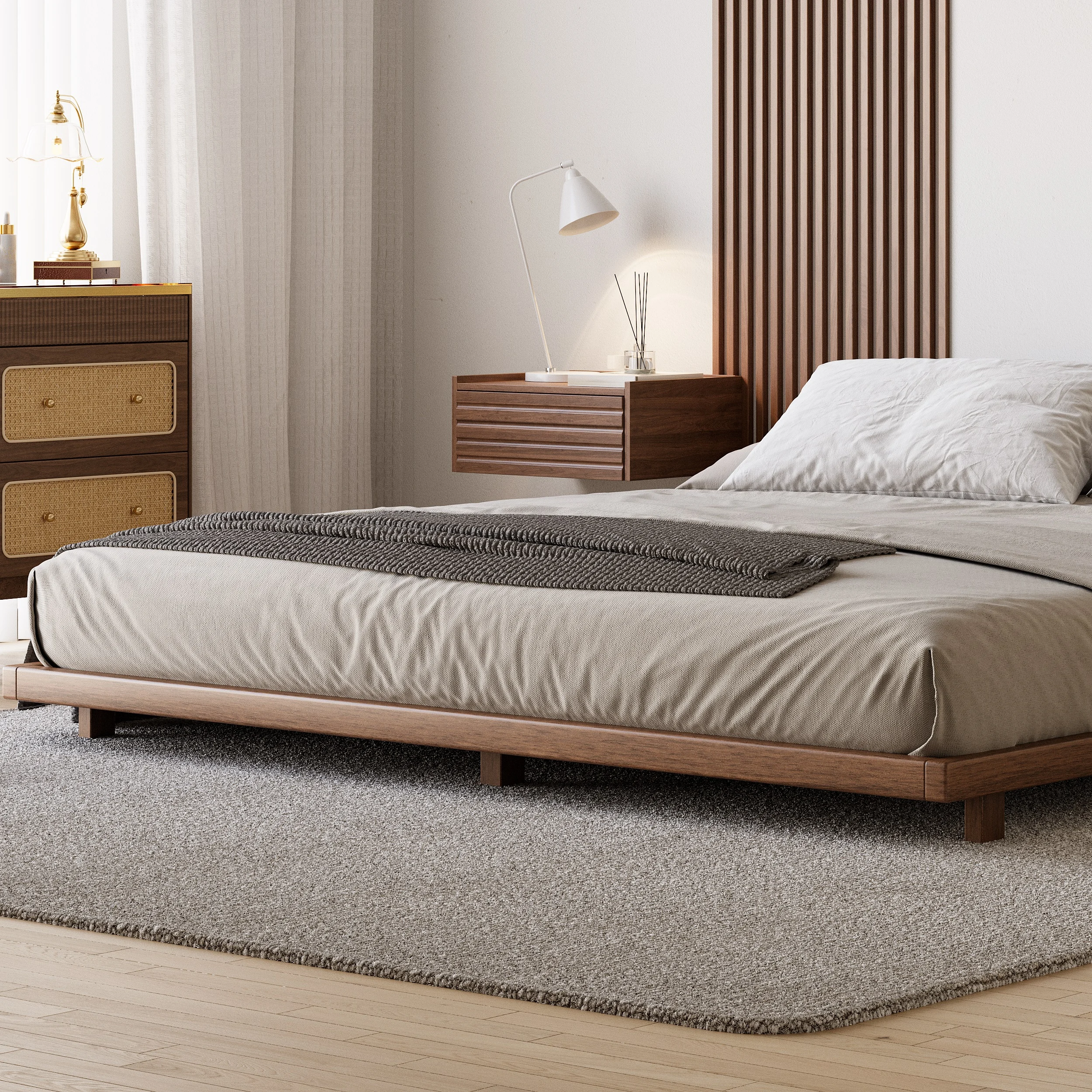 A minimalist bedroom featuring a low-profile wooden bed with a matching headboard and neutral bedding in beige and gray tones