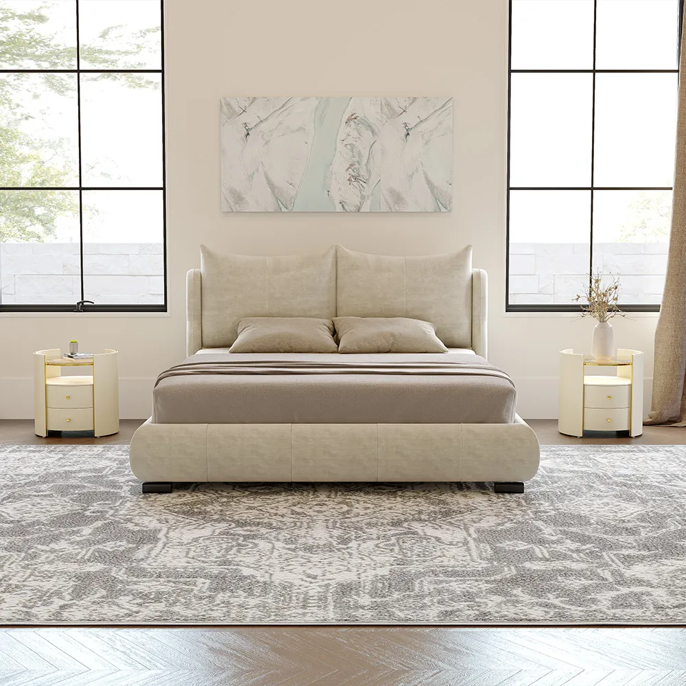 Beige upholstered bed with rounded frame, cushioned headboard, and neutral bedding in a modern bedroom.