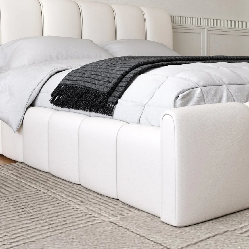 A modern bedroom featuring a white upholstered bed with a tall, vertically paneled headboard and matching footboard.