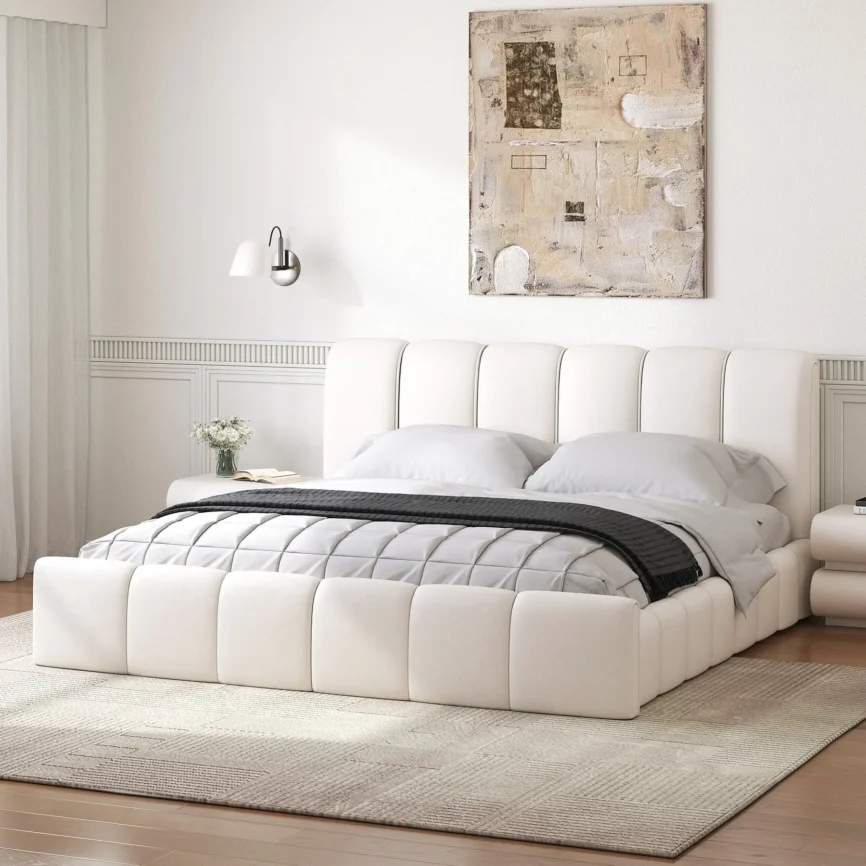 A modern bedroom featuring a white upholstered bed with a tall, vertically paneled headboard and matching footboard.