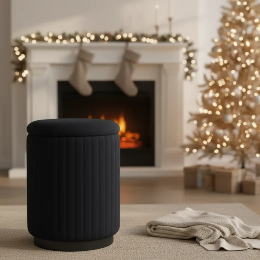 black cylindrical ottoman with vertical ribbed upholstery and cushioned top in cozy living room setting