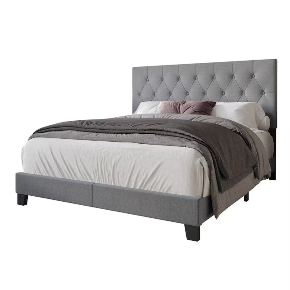 Gray tufted queen bed with white and mauve bedding, matching nightstands, and black sconces in a modern bedroom.