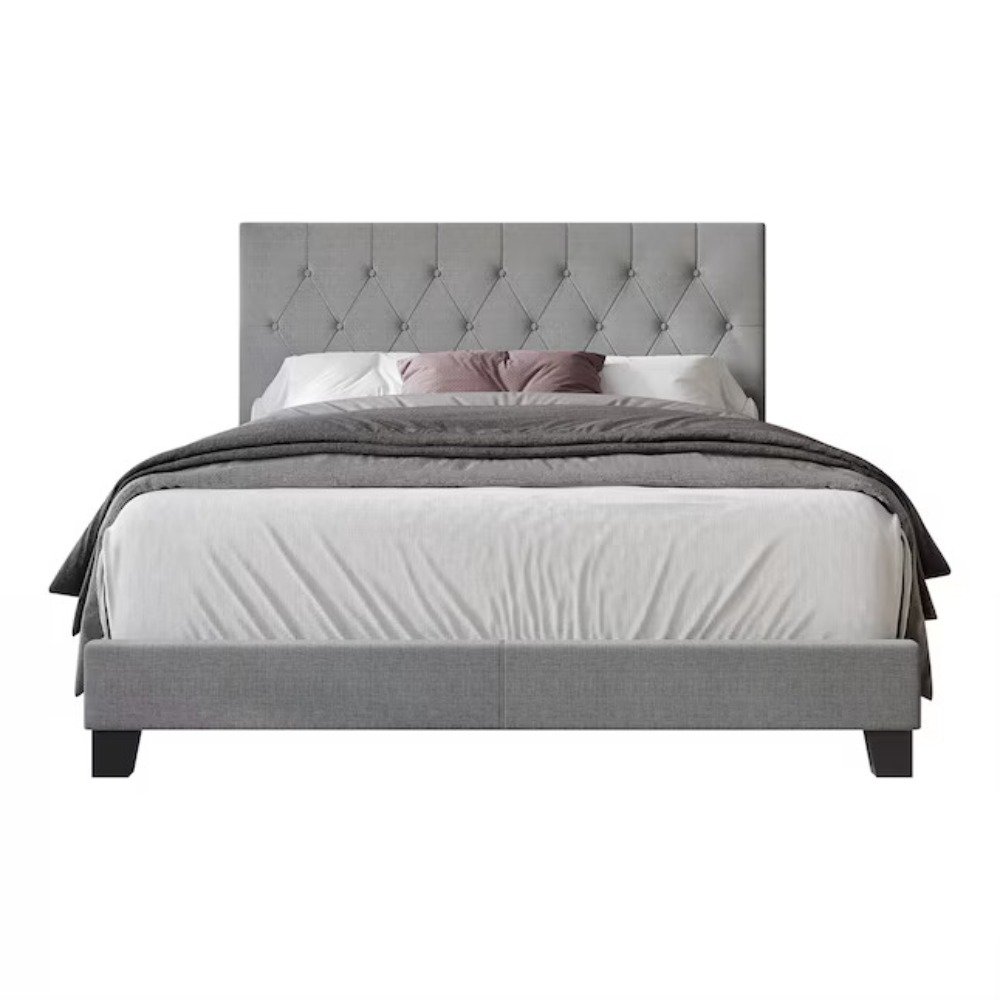 Gray tufted queen bed with white and mauve bedding, matching nightstands, and black sconces in a modern bedroom.