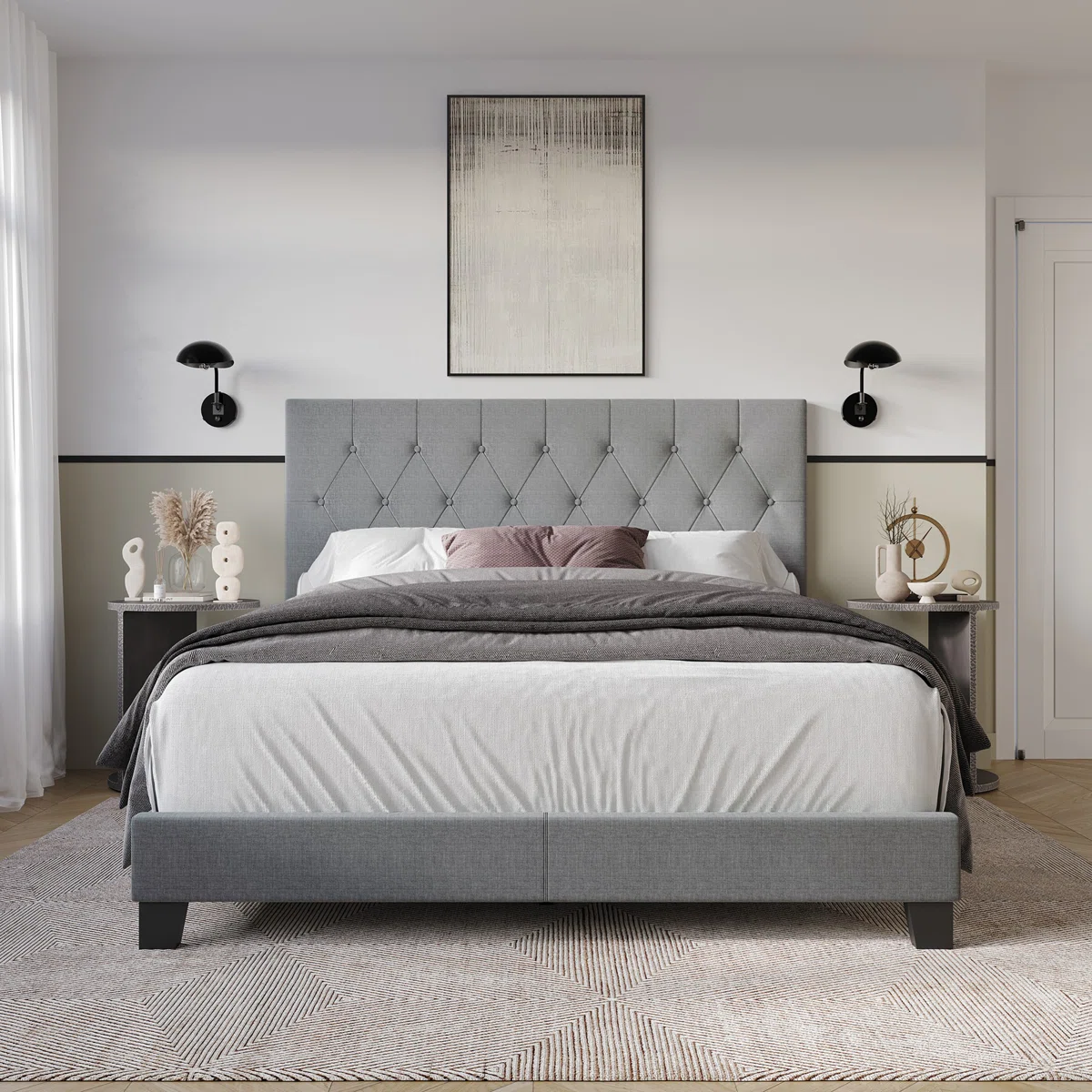 Gray tufted queen bed with white and mauve bedding, matching nightstands, and black sconces in a modern bedroom.