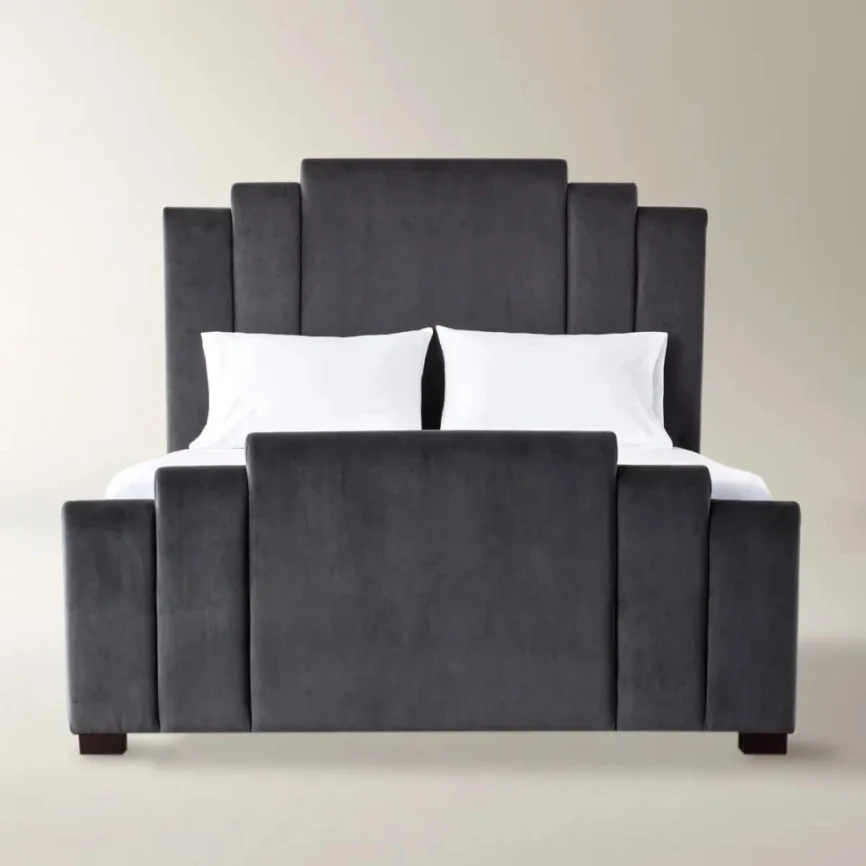 Gunmetal velvet bed with geometric tufted headboard and footboard, styled with white bedding in a modern room.