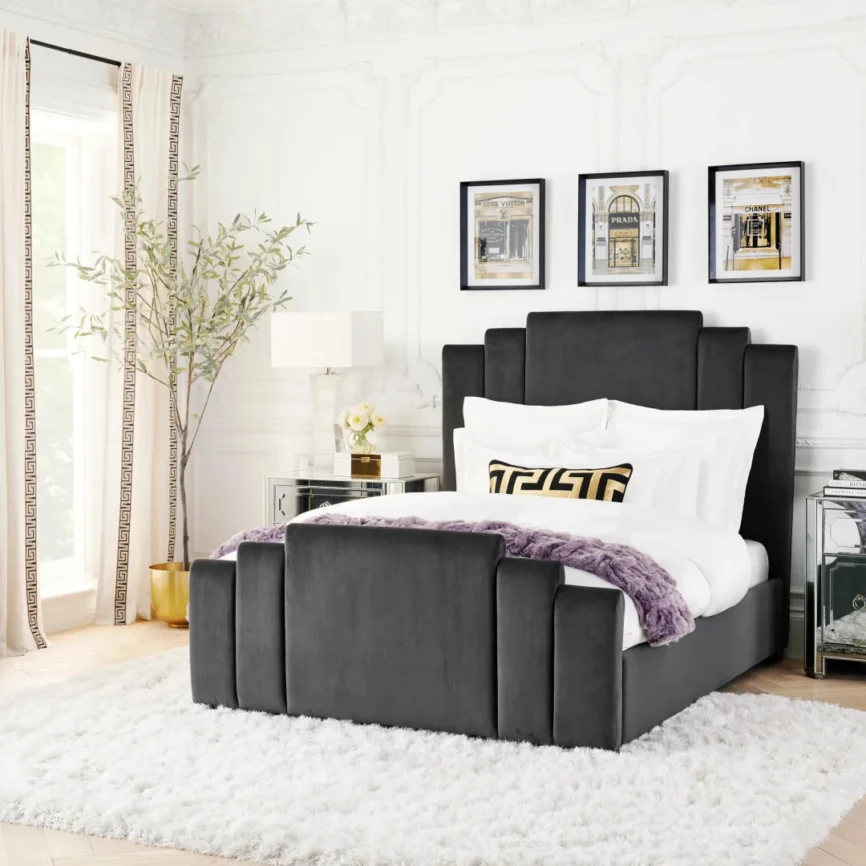 Gunmetal velvet bed with geometric tufted headboard and footboard, styled with white bedding in a modern room.